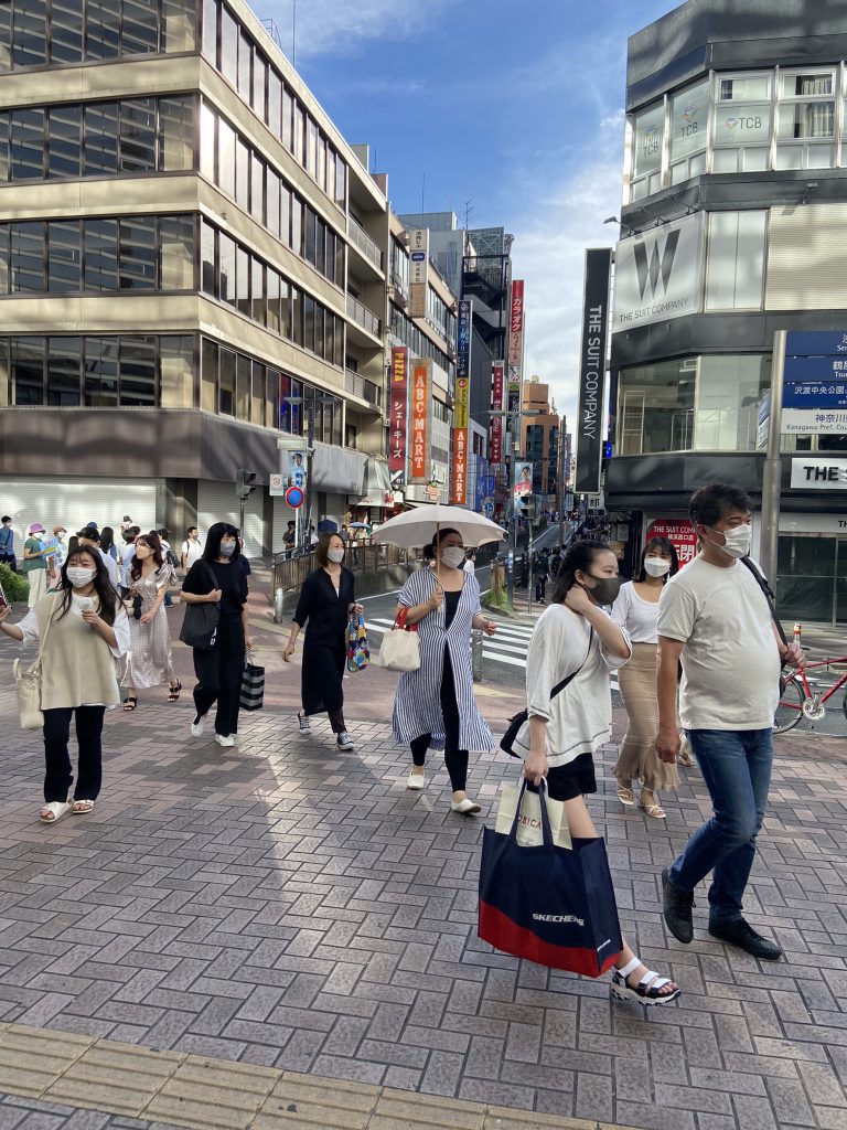 横浜駅近辺の通路の画像。数人が行き来。。ビルが軒を並べている。